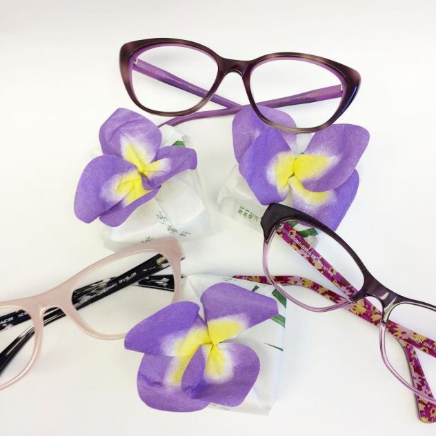 Photo of flowers and Coach and Lafont eyeglasses
