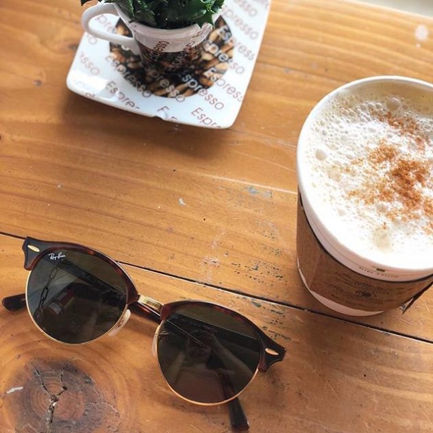 Ray Ban sunglasses and a cup of coffee