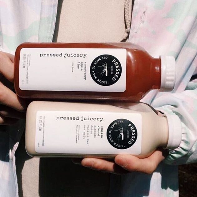 Two bottle of Pressed Juicery , Strawberry apple and Vanilla Almond juice.